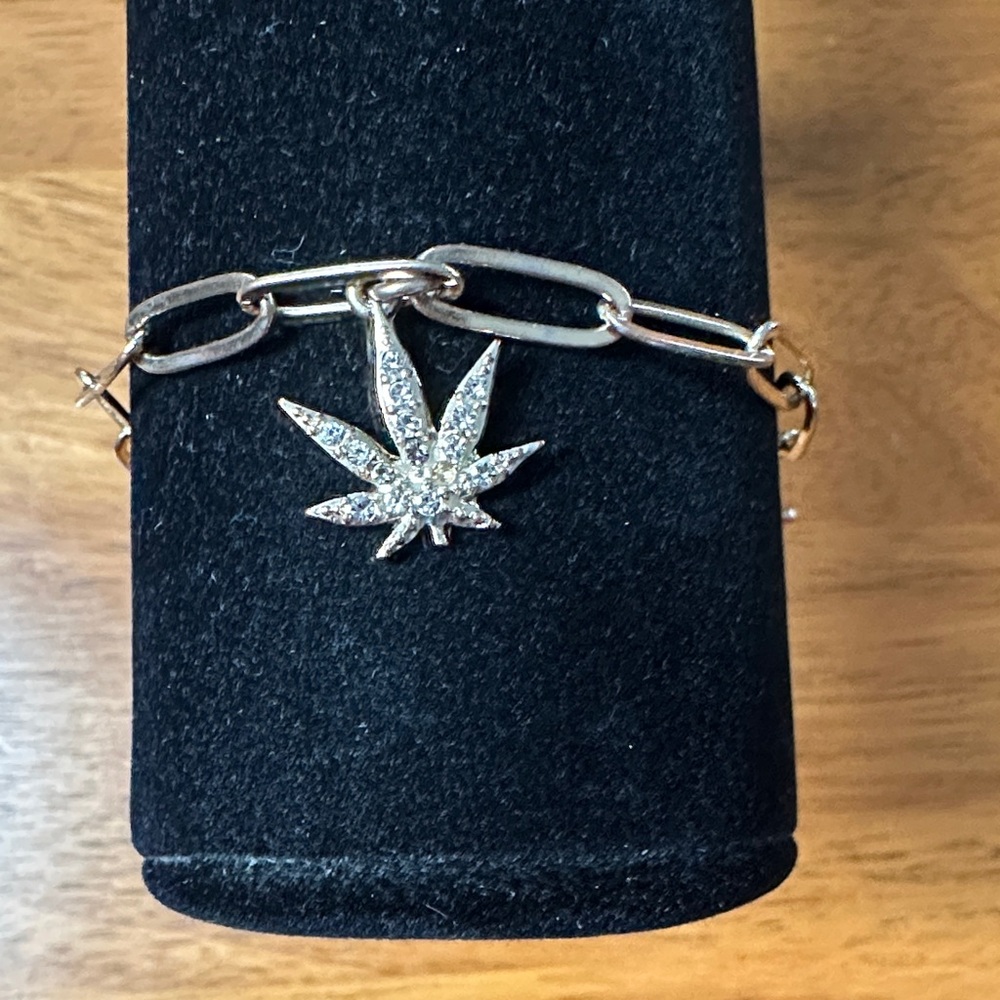 Goldtone Paperclip Chain Bracelet with Leaf Pendant and White Crystals.